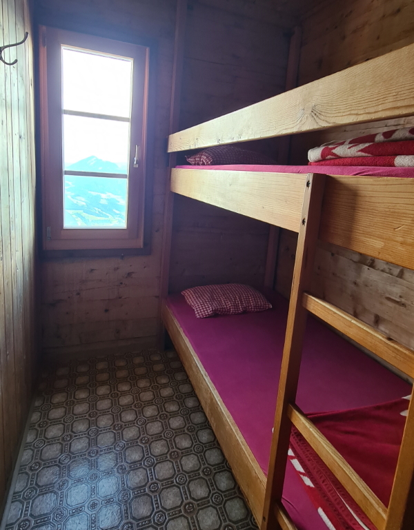 A wooden bunk bed room in Bayreuther Hütte. A typical cosy room in an Alpine hut