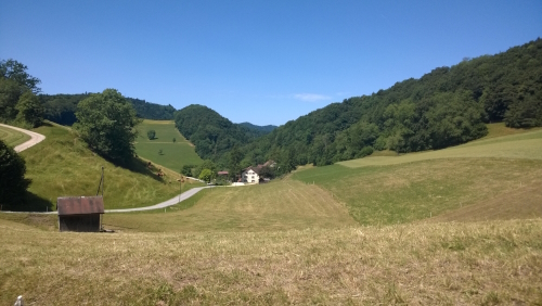 View across fields to a farm on Stage 2 of the Swiss Jura Crest Trail 