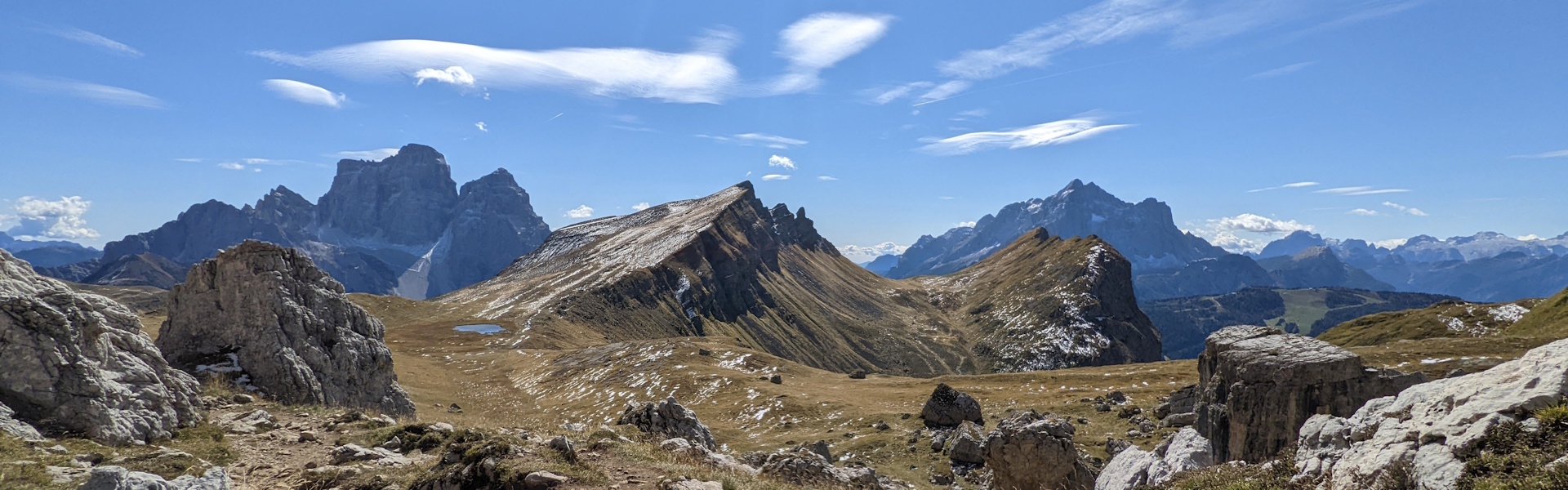 A remote section of the Alta Via 1 trail between Rifugio Averau and Rifugio Staulanza. A striking ridgeline in the foreground surrounding by the higher peaks from teh surrounding areas. 