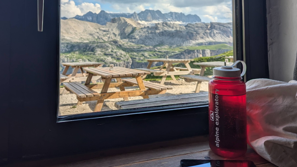 An Alpine Exploratory water bottle in the window at Rifugio Puez, Italian Dolomites