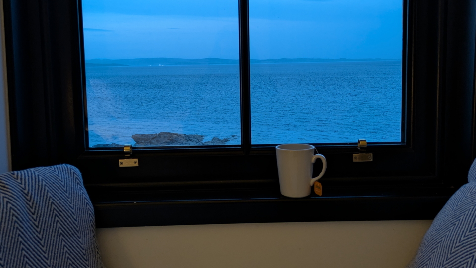 The sea through a window with a mug of coffee, Arran