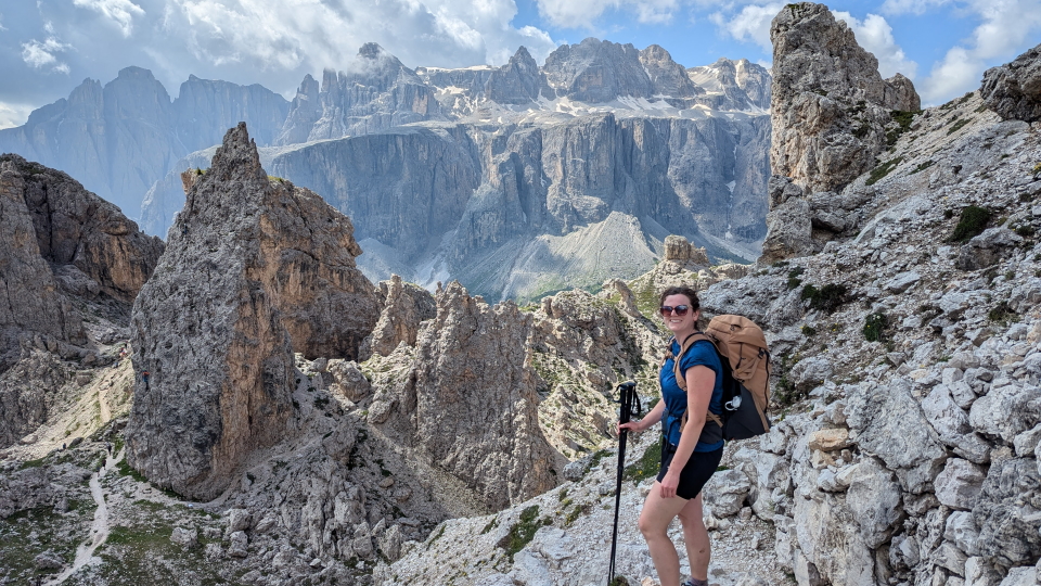 Alpine Exploratory's Nicky with the Sella massif, Dolomites
