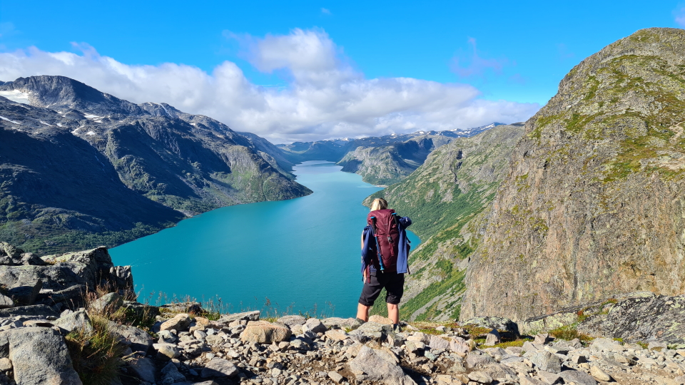 Hiker looking down Lake Gjende from the Besseggen Ridge