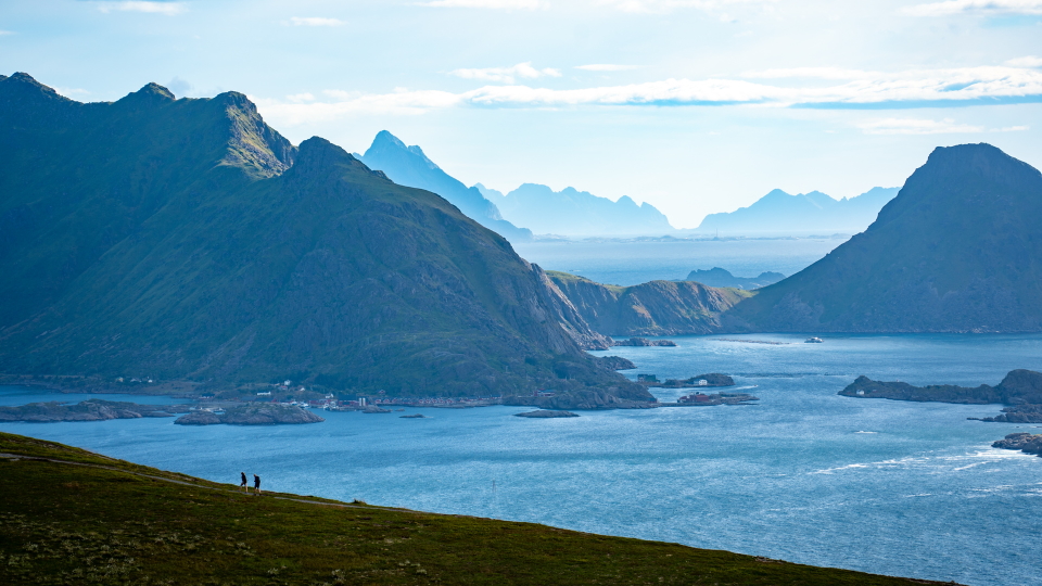 Lofoten trekkers in front of a fabulous Lofoten seascape and mountain-scape