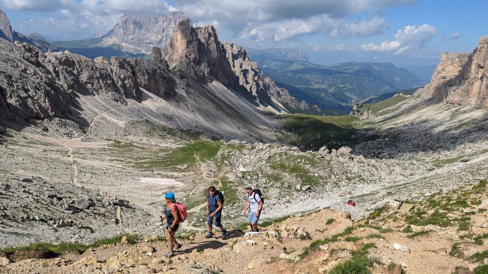 Three hikers on the Alta Via 2 in the Italian Dolomites